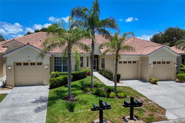 8804 Middlebrook Dr Unit 102, Fort Myers, FL 33908 - view of front of property with a tiled roof, concrete driveway, stucco siding, and a garage
