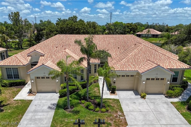 8804 Middlebrook Dr Unit 102, Fort Myers, FL 33908 - mediterranean / spanish-style house with a tiled roof, concrete driveway, an attached garage, and stucco siding