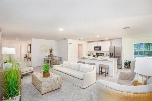 407 SW 19th Ave, Cape Coral, FL 33991 - living room featuring light carpet and recessed lighting
