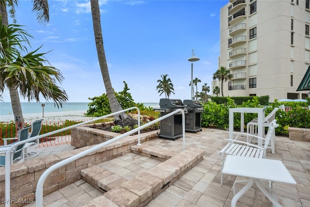 3003 Gulf Shore Blvd N Unit 404, Naples, FL 34103 - view of patio with a water view and grilling area