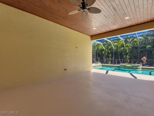 5667 Winkler Rd, Fort Myers, FL 33919 - view of pool featuring a patio area, ceiling fan, a pool with connected hot tub, and glass enclosure