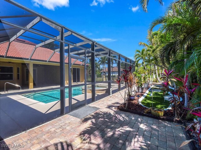 5667 Winkler Rd, Fort Myers, FL 33919 - swimming pool featuring a patio, an in-ground hot tub, ceiling fan, and a lanai