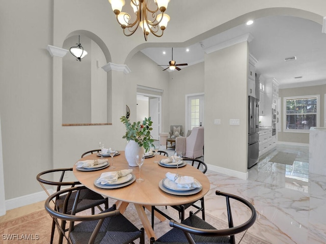 5667 Winkler Rd, Fort Myers, FL 33919 - dining area with arched walkways, recessed lighting, crown molding, baseboards, and a chandelier