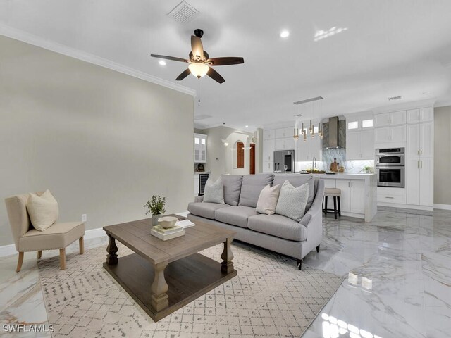 5667 Winkler Rd, Fort Myers, FL 33919 - living area featuring light marble finish floors, a ceiling fan, arched walkways, recessed lighting, and baseboards