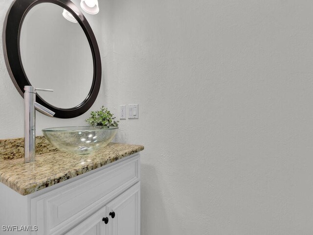 5667 Winkler Rd, Fort Myers, FL 33919 - bathroom featuring vanity and a textured wall