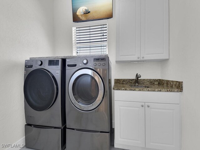 5667 Winkler Rd, Fort Myers, FL 33919 - laundry room with washer and dryer and cabinet space