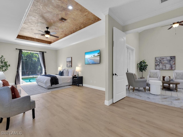 5667 Winkler Rd, Fort Myers, FL 33919 - bedroom featuring a raised ceiling, access to exterior, light wood-style floors, ornamental molding, and baseboards
