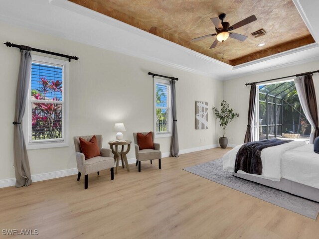 5667 Winkler Rd, Fort Myers, FL 33919 - bedroom featuring a raised ceiling, light wood-style flooring, access to outside, and baseboards