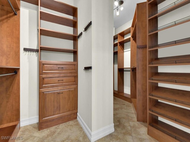 5667 Winkler Rd, Fort Myers, FL 33919 - walk in closet featuring light tile patterned floors