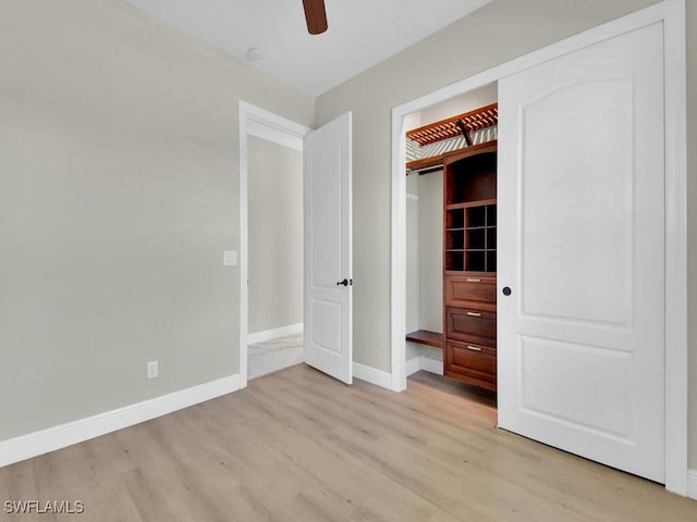 5667 Winkler Rd, Fort Myers, FL 33919 - unfurnished bedroom with light wood-type flooring, baseboards, and a ceiling fan