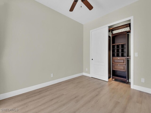 5667 Winkler Rd, Fort Myers, FL 33919 - unfurnished bedroom with wood finished floors, baseboards, and a ceiling fan