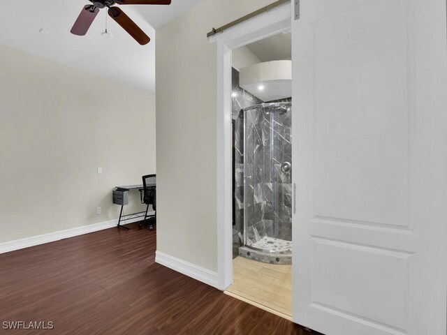5667 Winkler Rd, Fort Myers, FL 33919 - unfurnished room with a barn door, ceiling fan, wood finished floors, and baseboards