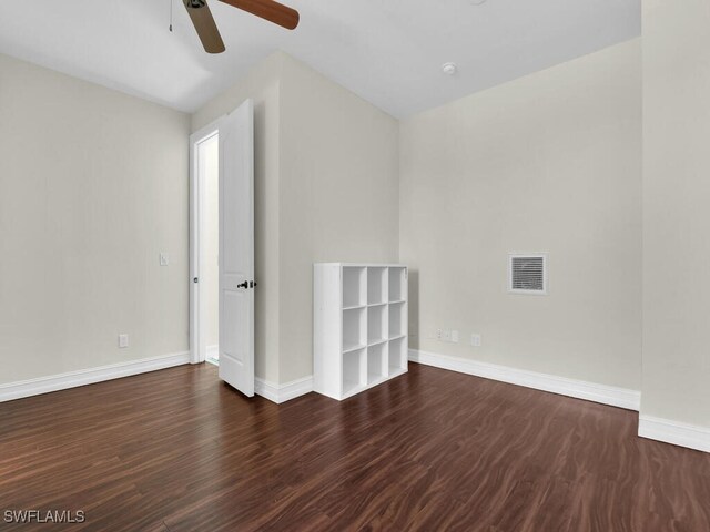 5667 Winkler Rd, Fort Myers, FL 33919 - unfurnished room with ceiling fan, baseboards, and dark wood-style flooring