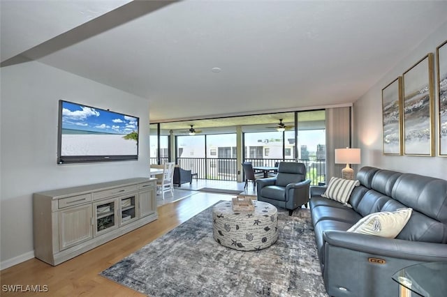 929 Collier Ct Unit B401, Marco Island, FL 34145 - living room with light wood-type flooring, a wall of windows, and ceiling fan