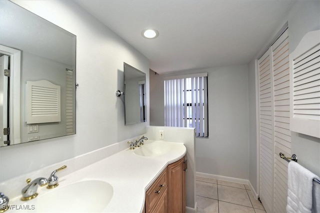 929 Collier Ct Unit B401, Marco Island, FL 34145 - bathroom with tile patterned flooring, double vanity, and baseboards