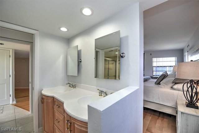 929 Collier Ct Unit B401, Marco Island, FL 34145 - ensuite bathroom featuring wood finished floors, an enclosed shower, double vanity, recessed lighting, and baseboards