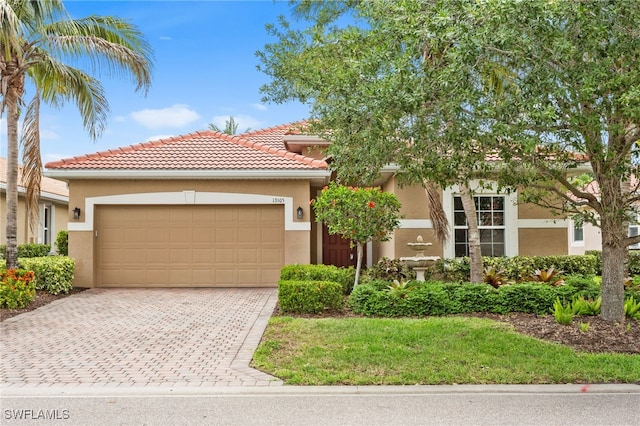 13105 Silver Thorn Loop, North Fort Myers, FL 33903 - view of front of home featuring an attached garage, stucco siding, driveway, and a tiled roof