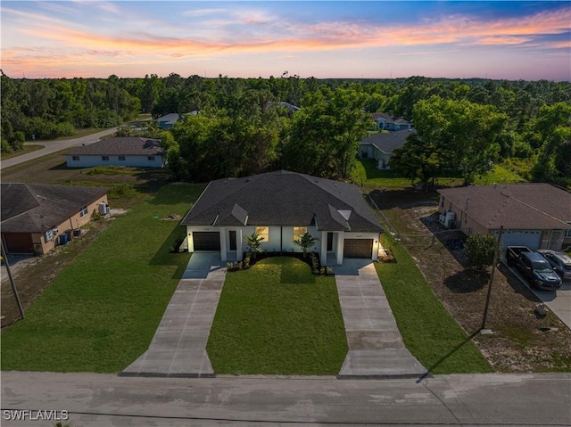 5205/5207 26th St SW, Lehigh Acres, FL 33973 - aerial view at dusk of a view of trees