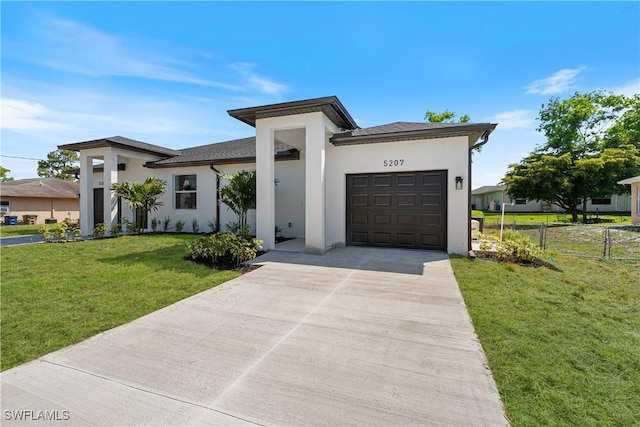 5205/5207 26th St SW, Lehigh Acres, FL 33973 - view of front facade with stucco siding, a garage, and driveway