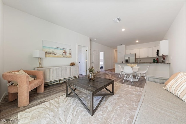 5205/5207 26th St SW, Lehigh Acres, FL 33973 - living room with light wood finished floors, recessed lighting, and baseboards