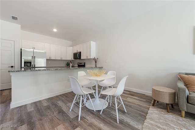 5205/5207 26th St SW, Lehigh Acres, FL 33973 - dining room featuring wood finished floors, recessed lighting, and baseboards