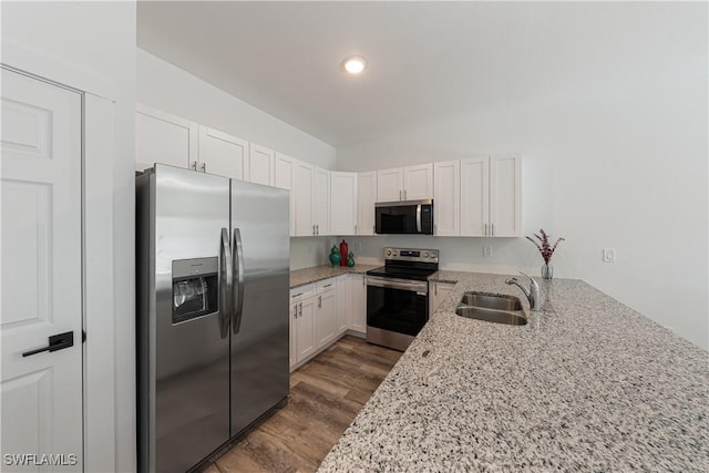 5205/5207 26th St SW, Lehigh Acres, FL 33973 - kitchen with stainless steel appliances, a sink, dark wood-style floors, light stone countertops, and white cabinetry