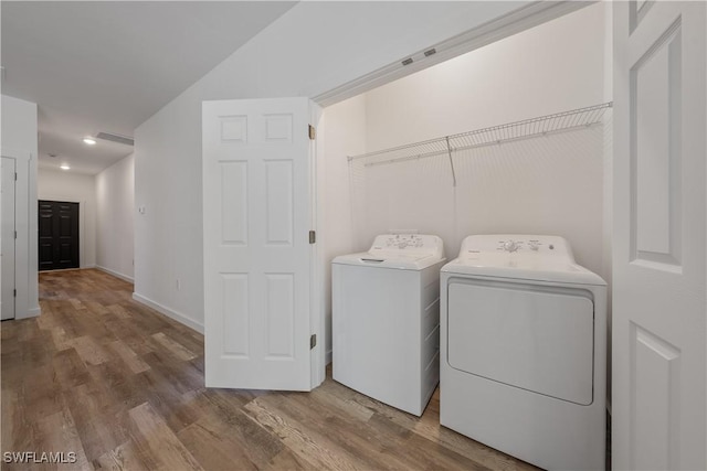 5205/5207 26th St SW, Lehigh Acres, FL 33973 - laundry room featuring separate washer and dryer, wood finished floors, baseboards, and recessed lighting