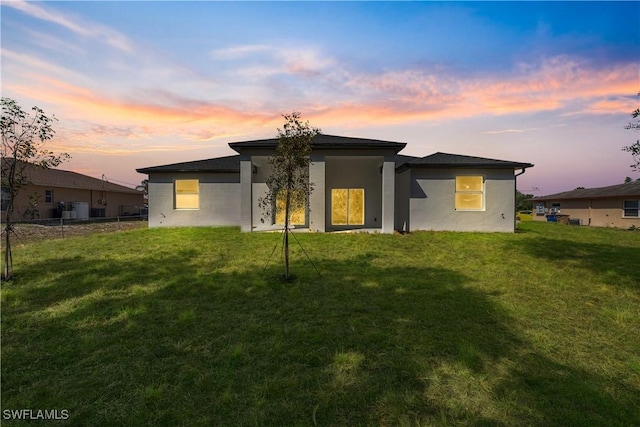5205/5207 26th St SW, Lehigh Acres, FL 33973 - back of house at dusk with stucco siding