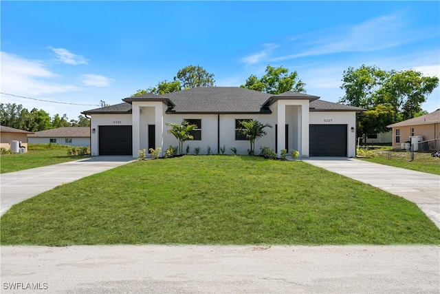 5205/5207 26th St SW, Lehigh Acres, FL 33973 - prairie-style house featuring an attached garage, concrete driveway, a front yard, and stucco siding