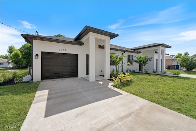 5205/5207 26th St SW, Lehigh Acres, FL 33973 - view of front of house with an attached garage, stucco siding, driveway, and a front yard