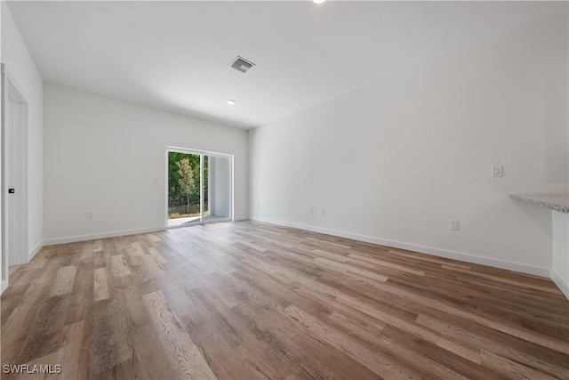 5205/5207 26th St SW, Lehigh Acres, FL 33973 - unfurnished room featuring light wood-style flooring, baseboards, and recessed lighting