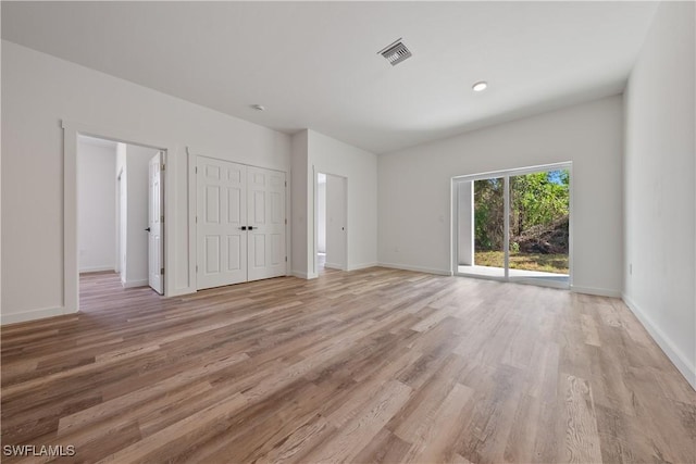 5205/5207 26th St SW, Lehigh Acres, FL 33973 - unfurnished bedroom with light wood-type flooring, access to exterior, baseboards, and a closet