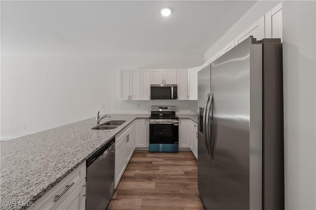 5205/5207 26th St SW, Lehigh Acres, FL 33973 - kitchen featuring stainless steel appliances, a sink, dark wood finished floors, white cabinetry, and recessed lighting