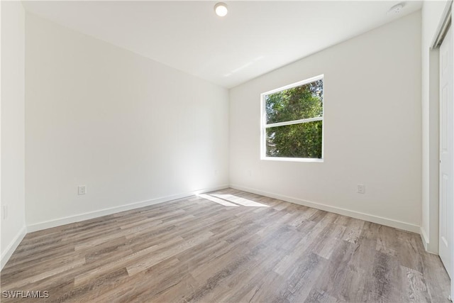5205/5207 26th St SW, Lehigh Acres, FL 33973 - unfurnished room with light wood finished floors and baseboards