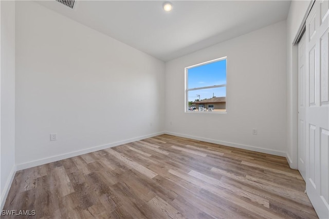 5205/5207 26th St SW, Lehigh Acres, FL 33973 - unfurnished bedroom with light wood-style flooring, baseboards, and a closet