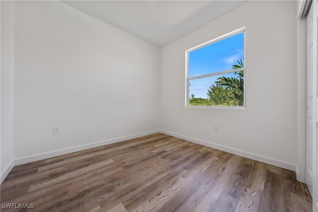 5205/5207 26th St SW, Lehigh Acres, FL 33973 - empty room featuring wood finished floors and baseboards