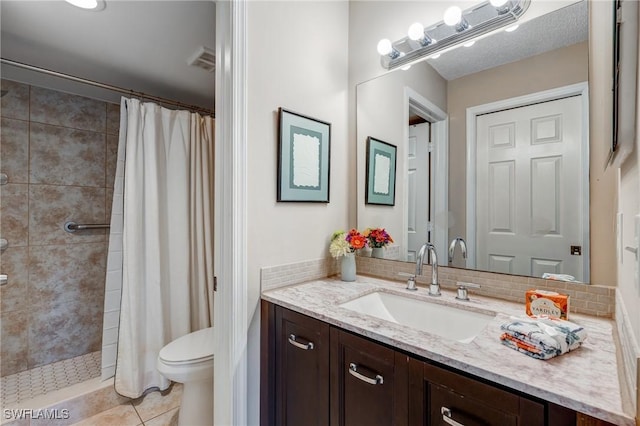 7065 Dennis Cir Unit F204, Naples, FL 34104 - bathroom with toilet, tiled shower, vanity, and tile patterned floors