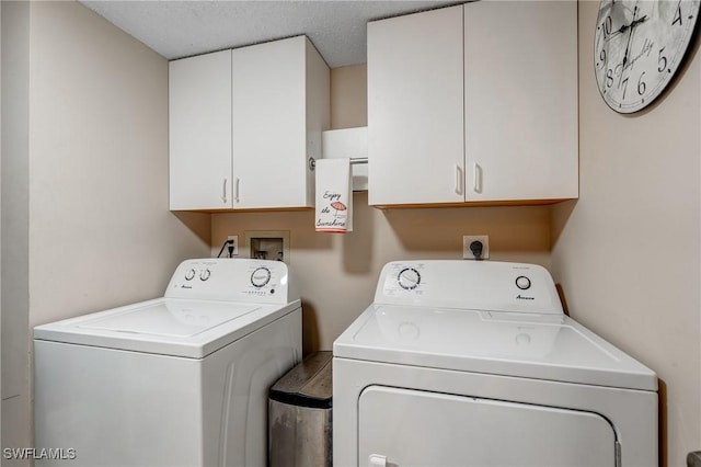 7065 Dennis Cir Unit F204, Naples, FL 34104 - laundry room with washer and clothes dryer, cabinet space, and a textured ceiling