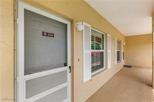 9851 Costa Mesa Ln Unit 308, Bonita Springs, FL 34135 - doorway to property with stucco siding