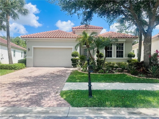5489 Whispering Willow Way, Fort Myers, FL 33908 - mediterranean / spanish-style home with driveway, an attached garage, and stucco siding