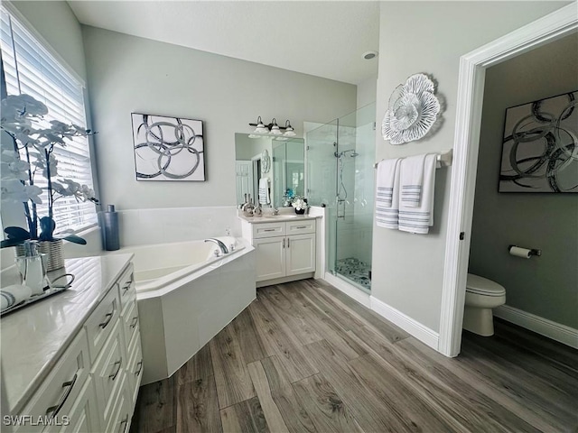 5489 Whispering Willow Way, Fort Myers, FL 33908 - full bath featuring wood finished floors, a stall shower, vanity, a bath, and toilet