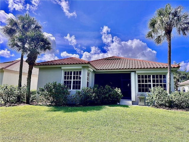 5489 Whispering Willow Way, Fort Myers, FL 33908 - view of front of house featuring a tiled roof, a front yard, and stucco siding