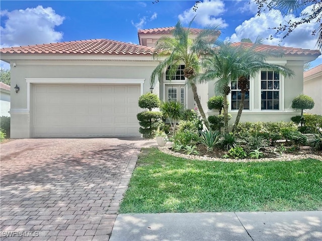 5489 Whispering Willow Way, Fort Myers, FL 33908 - mediterranean / spanish-style house with decorative driveway, stucco siding, a garage, a tiled roof, and a front lawn