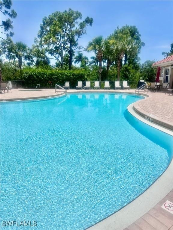 5489 Whispering Willow Way, Fort Myers, FL 33908 - community pool with a patio