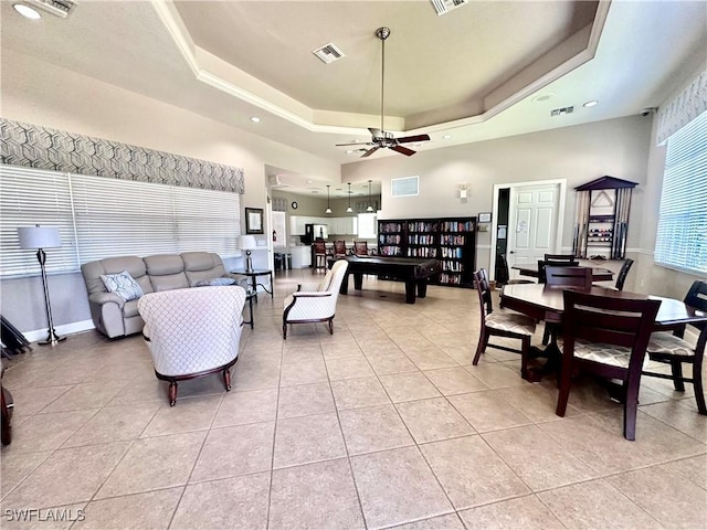 5489 Whispering Willow Way, Fort Myers, FL 33908 - living room featuring a tray ceiling, light tile patterned floors, a ceiling fan, recessed lighting, and a towering ceiling