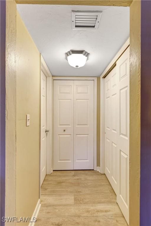 2100 Barkeley Ln Unit 1, Fort Myers, FL 33907 - corridor with light wood-type flooring and baseboards