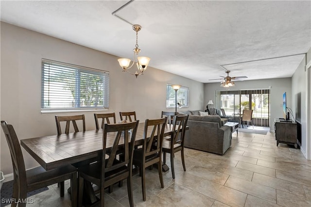 2100 Barkeley Ln Unit 1, Fort Myers, FL 33907 - dining space with healthy amount of natural light, a ceiling fan, a chandelier, and baseboards