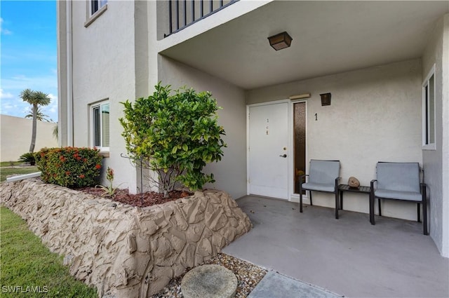2100 Barkeley Ln Unit 1, Fort Myers, FL 33907 - entrance to property with stucco siding and a patio