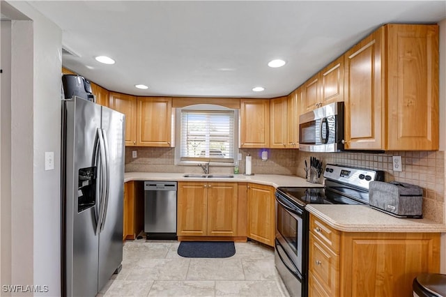 2100 Barkeley Ln Unit 1, Fort Myers, FL 33907 - kitchen featuring appliances with stainless steel finishes, a sink, light countertops, decorative backsplash, and recessed lighting