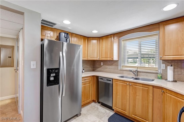 2100 Barkeley Ln Unit 1, Fort Myers, FL 33907 - kitchen with stainless steel appliances, a sink, light countertops, decorative backsplash, and light tile patterned floors